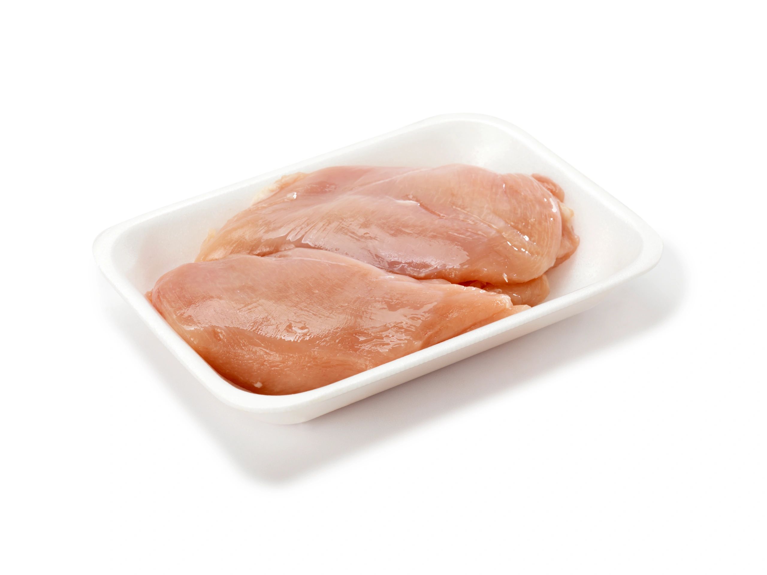 Fresh raw chicken breasts in a tray