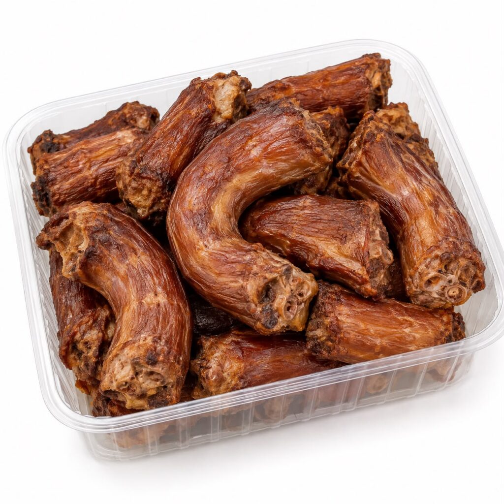Smoked turkey necks in a clear tray